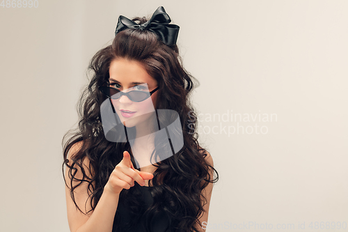 Image of Portrait of beautiful young woman isolated on grey studio background
