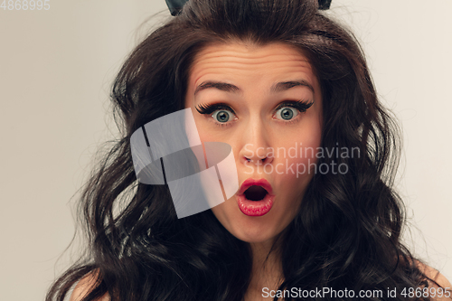 Image of Close up portrait of beautiful young woman isolated on grey studio background