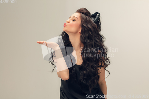 Image of Portrait of beautiful young woman isolated on grey studio background