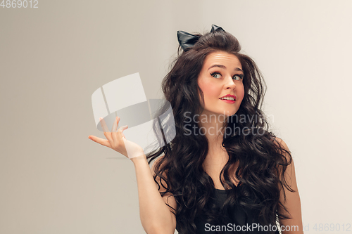 Image of Portrait of beautiful young woman isolated on grey studio background