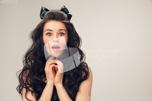Image of Portrait of beautiful young woman isolated on grey studio background