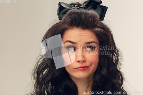 Image of Close up portrait of beautiful young woman isolated on grey studio background