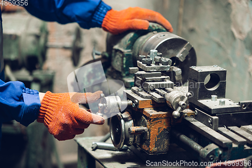 Image of Close up of hands of repairman, professional builder working outdoors, repairing