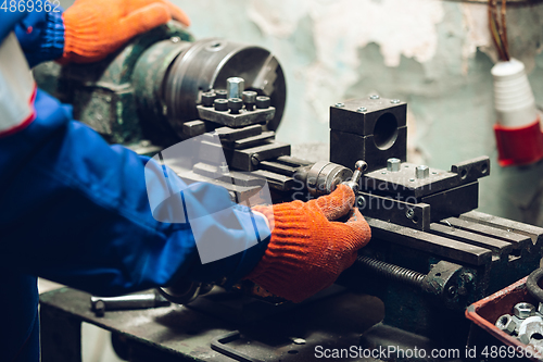 Image of Close up of hands of repairman, professional builder working outdoors, repairing