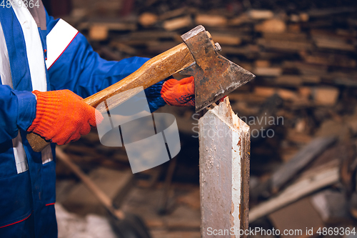 Image of Close up of hands of repairman, professional builder working outdoors, repairing