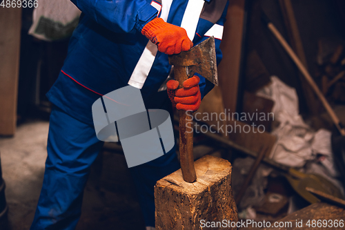 Image of Close up of hands of repairman, professional builder working outdoors, repairing