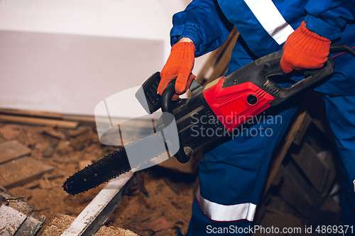 Image of Close up of hands of repairman, professional builder working outdoors, repairing