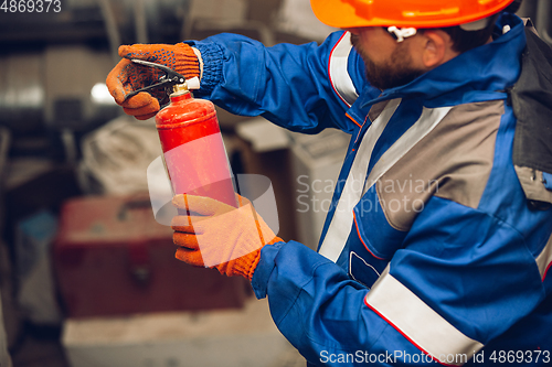 Image of Close up of hands of repairman, professional builder working outdoors, repairing