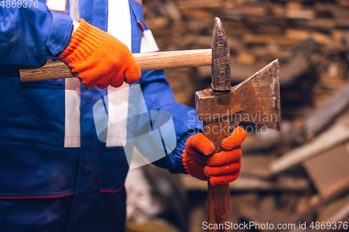 Image of Close up of hands of repairman, professional builder working outdoors, repairing