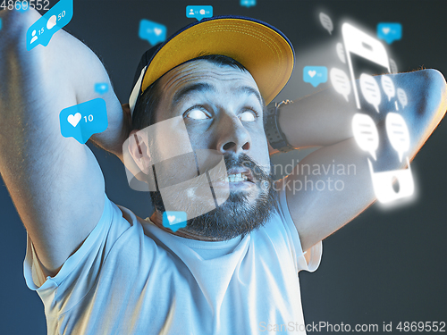 Image of Man using interface modern technology and digital layer effect for social media displaying, getting crazy of likes and comments