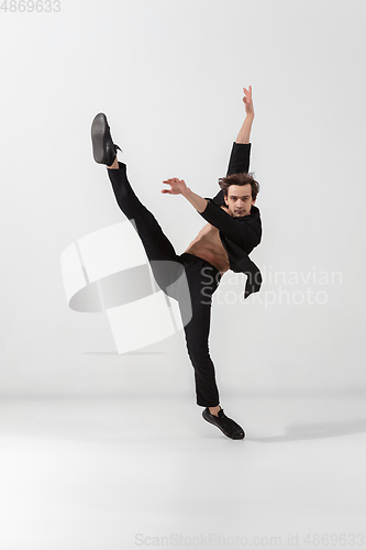 Image of Young and graceful ballet dancer in minimal black style isolated on white studio background