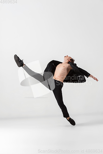 Image of Young and graceful ballet dancer in minimal black style isolated on white studio background