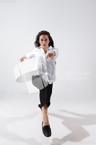 Image of Young and graceful ballet dancer in minimal black style isolated on white studio background