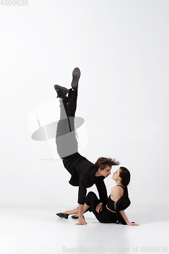 Image of Young and graceful ballet dancers in minimal black style isolated on white studio background