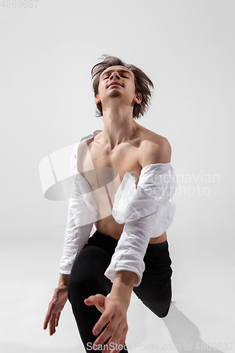 Image of Young and graceful ballet dancer in minimal black style isolated on white studio background