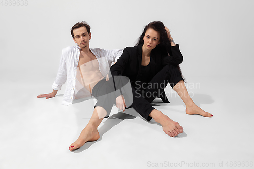 Image of Young and graceful ballet dancers in minimal black style isolated on white studio background