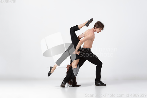 Image of Young and graceful ballet dancers in minimal black style isolated on white studio background