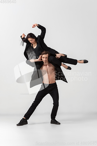 Image of Young and graceful ballet dancers in minimal black style isolated on white studio background