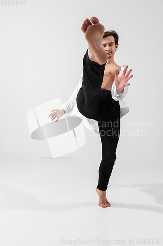 Image of Young and graceful ballet dancer in minimal black style isolated on white studio background