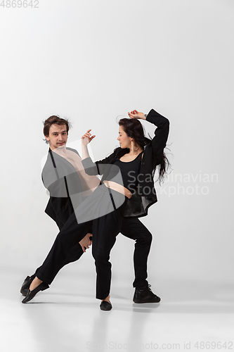 Image of Young and graceful ballet dancers in minimal black style isolated on white studio background