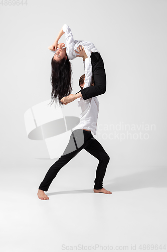 Image of Young and graceful ballet dancers in minimal black style isolated on white studio background