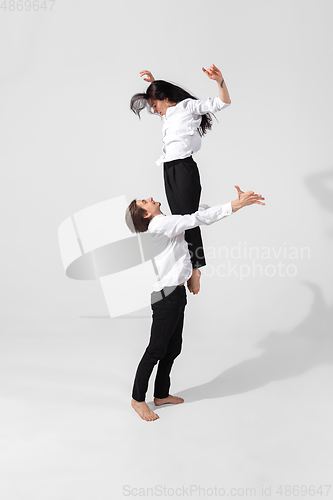 Image of Young and graceful ballet dancers in minimal black style isolated on white studio background