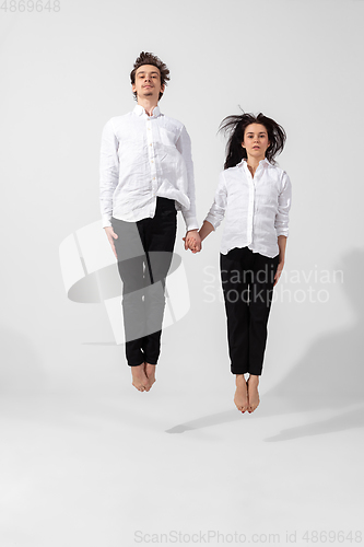 Image of Young and graceful ballet dancers in minimal black style isolated on white studio background