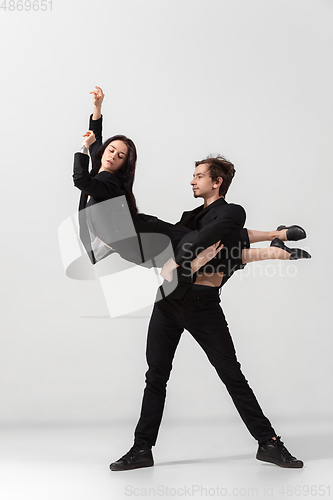 Image of Young and graceful ballet dancers in minimal black style isolated on white studio background