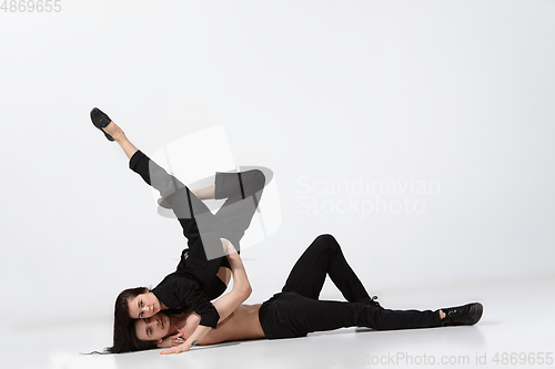 Image of Young and graceful ballet dancers in minimal black style isolated on white studio background