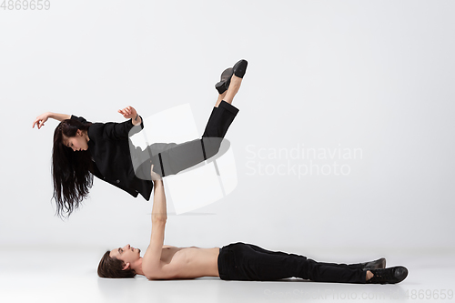 Image of Young and graceful ballet dancers in minimal black style isolated on white studio background