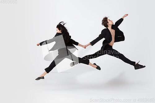 Image of Young and graceful ballet dancers in minimal black style isolated on white studio background