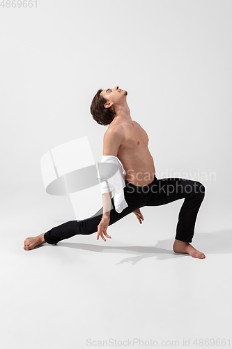 Image of Young and graceful ballet dancer in minimal black style isolated on white studio background