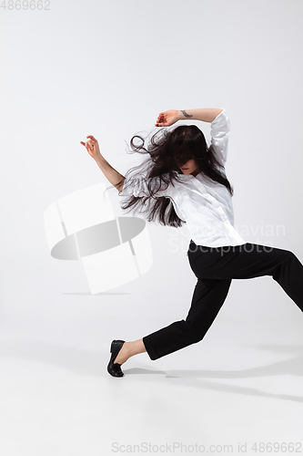 Image of Young and graceful ballet dancer in minimal black style isolated on white studio background