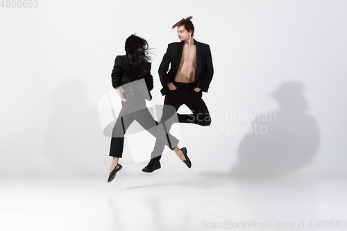 Image of Young and graceful ballet dancers in minimal black style isolated on white studio background