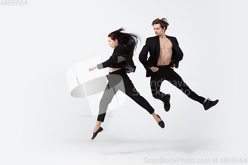 Image of Young and graceful ballet dancers in minimal black style isolated on white studio background