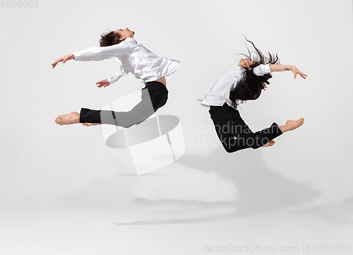 Image of Young and graceful ballet dancers in minimal black style isolated on white studio background