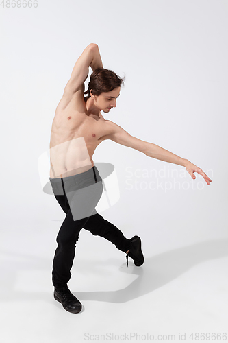 Image of Young and graceful ballet dancer in minimal black style isolated on white studio background