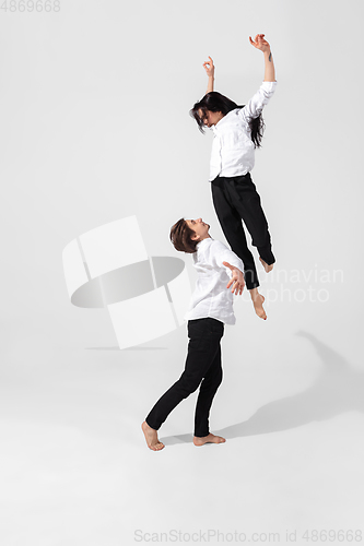 Image of Young and graceful ballet dancers in minimal black style isolated on white studio background