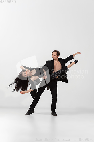 Image of Young and graceful ballet dancers in minimal black style isolated on white studio background