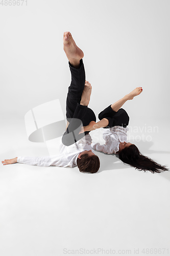 Image of Young and graceful ballet dancers in minimal black style isolated on white studio background