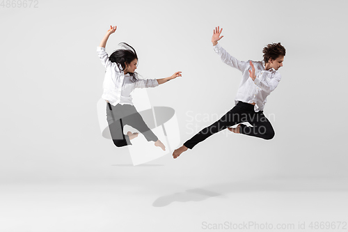 Image of Young and graceful ballet dancers in minimal black style isolated on white studio background