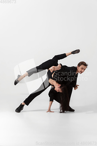 Image of Young and graceful ballet dancers in minimal black style isolated on white studio background