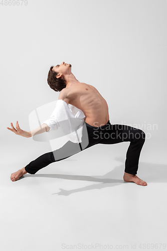 Image of Young and graceful ballet dancer in minimal black style isolated on white studio background