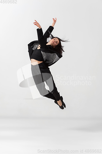 Image of Young and graceful ballet dancer in minimal black style isolated on white studio background