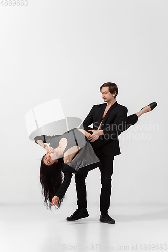 Image of Young and graceful ballet dancers in minimal black style isolated on white studio background