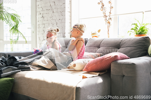 Image of Quiet little girls waking up in a bedroom in cute pajamas, home style and comfort