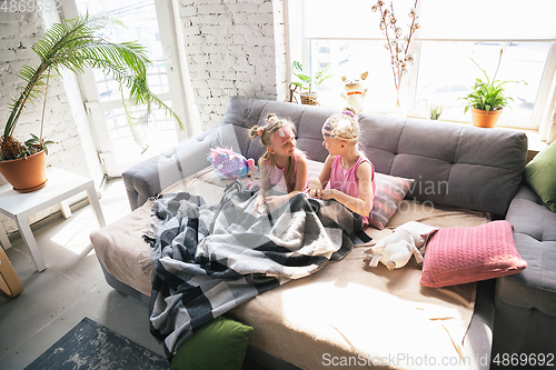 Image of Quiet little girls waking up in a bedroom in cute pajamas, home style and comfort