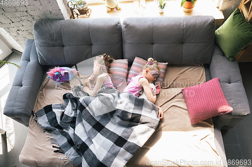 Image of Quiet little girls sleeping in a bedroom in cute pajamas, home style and comfort