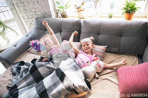 Image of Quiet little girls waking up in a bedroom in cute pajamas, home style and comfort