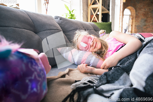 Image of Quiet little girls sleeping in a bedroom in cute pajamas, home style and comfort